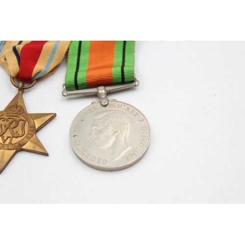 129 - Four assorted medals, three WWII mounted medals comprising The 1939-1945 Star, The Africa Star and T... 