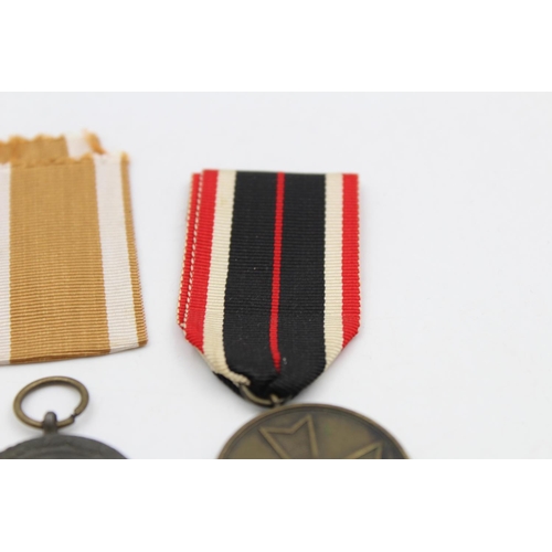 131 - Two WWII German medals, West Wall with packet and War Merit