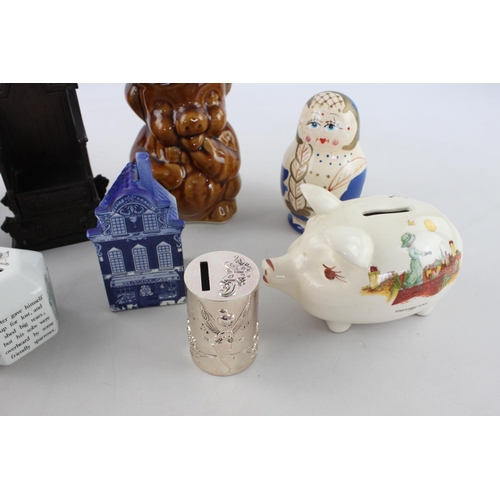 257 - Nine assorted money boxes to include Wedgwood Peter Rabbit, Delft Blue, Snoopy etc.