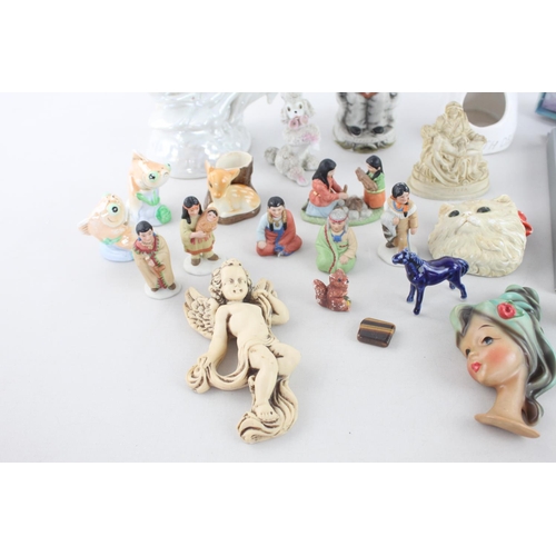 259 - A collection of ceramic figurines to include boxed Royal Worcester Guardian Angel, mid 20th century ... 