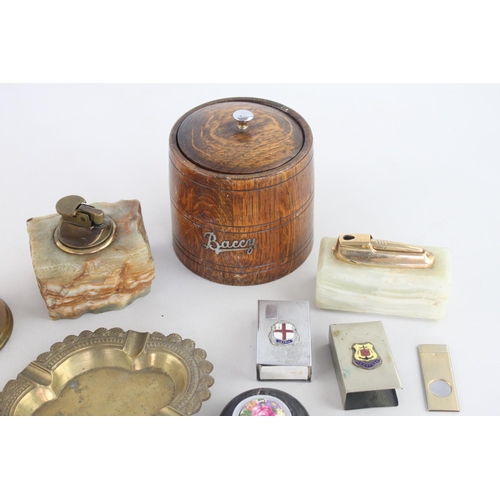 261 - A collection of assorted smoking accessories to include brass ashtray, oak 'baccy' box, Ronson onyx ... 