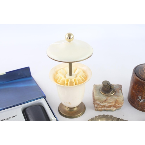 261 - A collection of assorted smoking accessories to include brass ashtray, oak 'baccy' box, Ronson onyx ... 