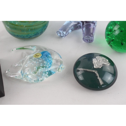 264 - A collection of eight assorted art glass paperweights to include Murano fish