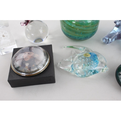 264 - A collection of eight assorted art glass paperweights to include Murano fish