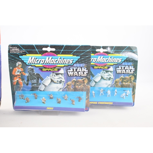 312 - Four carded action figurines to include Flintstones, two Star Wars Micro Machine and Kenner