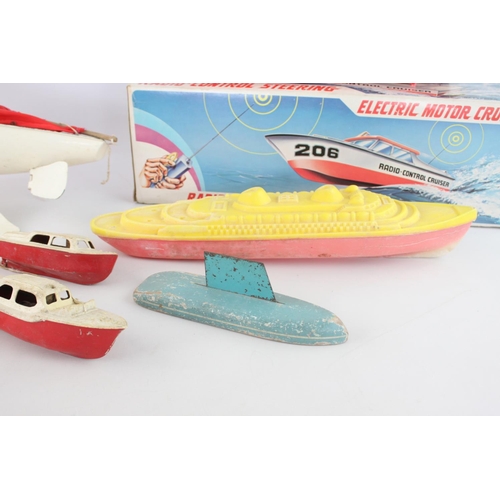 322 - Eight assorted vintage toy boats to include sail, radio controlled Electric Motor Cruiser, penguin e... 