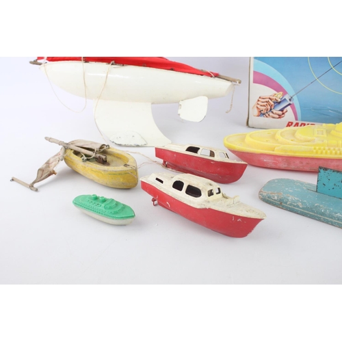 322 - Eight assorted vintage toy boats to include sail, radio controlled Electric Motor Cruiser, penguin e... 