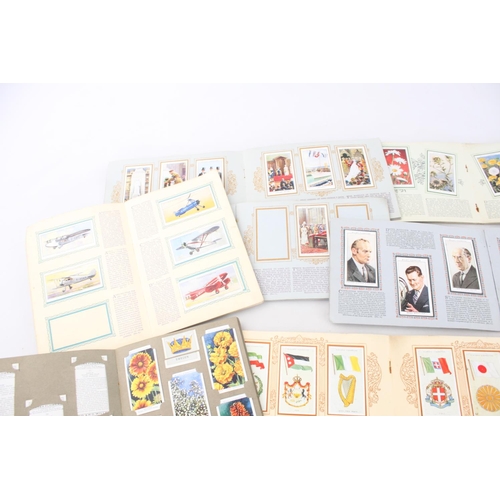 334 - A collection of fifteen assorted cigarette card albums to include W. D. & H. O. Wills Radio Celebrit... 