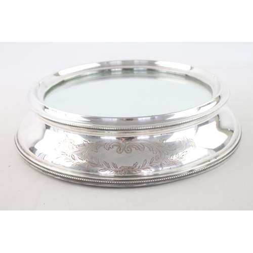 340 - A vintage silver plated mirrored wedding cake stand with engraved floral and scrolling leaves to for... 