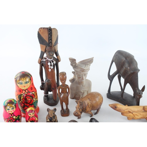 357 - A collection of assorted treenware to include, Russian dolls, ethnographic figurines, animal figurin... 