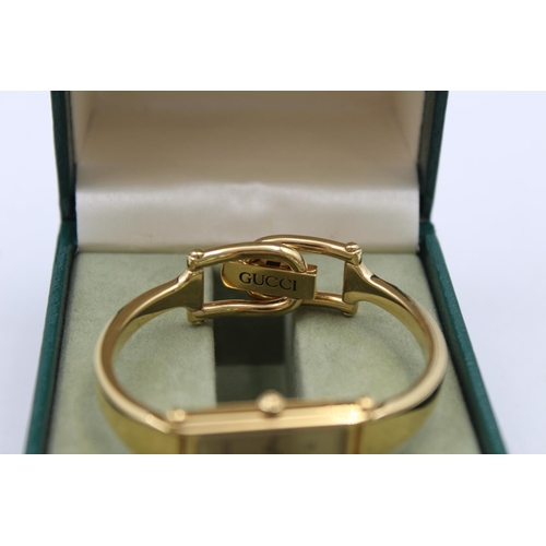 75 - A Gucci 1500 gold tone quartz ladies wristwatch with original box