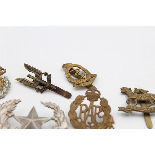 97 - Fifteen assorted vintage military cap badges to include Scottish, S.A.S, Royal West Kent etc.