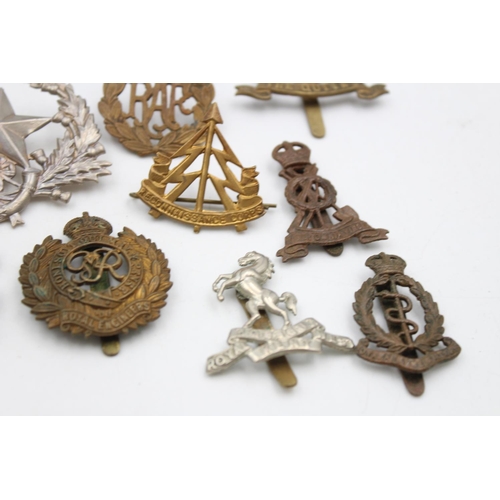 97 - Fifteen assorted vintage military cap badges to include Scottish, S.A.S, Royal West Kent etc.