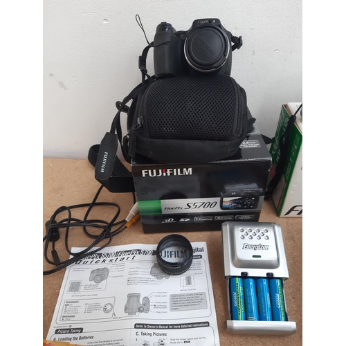 1105 - A box containing cased Pathéscope 10 x 50 binoculars, boxed and cased Fujiflm FinePix A607 digital c... 