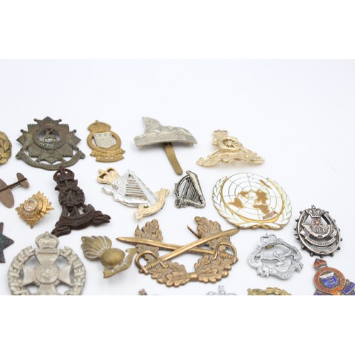 96 - A collection of assorted vintage badges to include two WWII A.R.P hallmarked sterling silver badges,... 