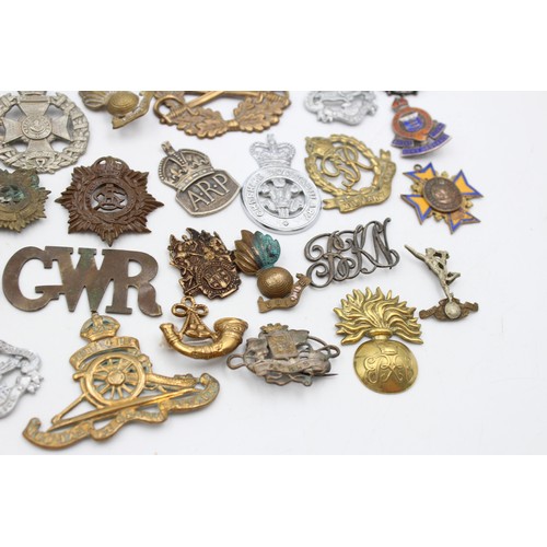 96 - A collection of assorted vintage badges to include two WWII A.R.P hallmarked sterling silver badges,... 