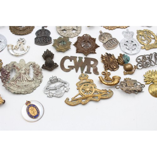 96 - A collection of assorted vintage badges to include two WWII A.R.P hallmarked sterling silver badges,... 