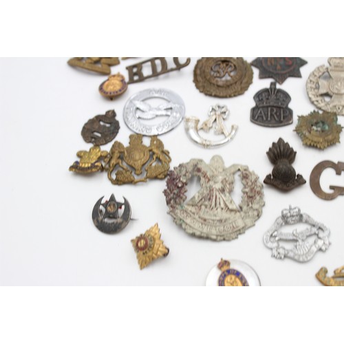 96 - A collection of assorted vintage badges to include two WWII A.R.P hallmarked sterling silver badges,... 