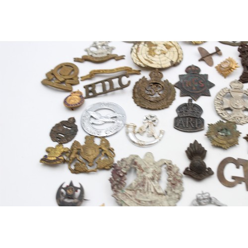 96 - A collection of assorted vintage badges to include two WWII A.R.P hallmarked sterling silver badges,... 