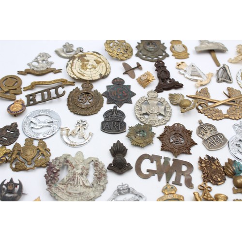 96 - A collection of assorted vintage badges to include two WWII A.R.P hallmarked sterling silver badges,... 