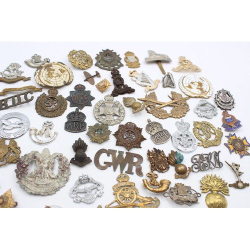 96 - A collection of assorted vintage badges to include two WWII A.R.P hallmarked sterling silver badges,... 