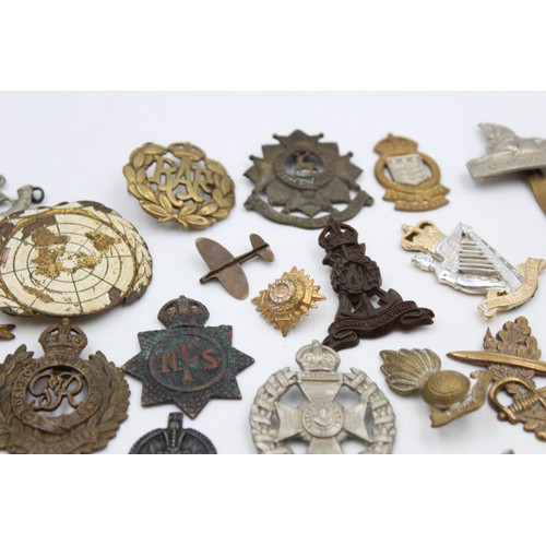 96 - A collection of assorted vintage badges to include two WWII A.R.P hallmarked sterling silver badges,... 