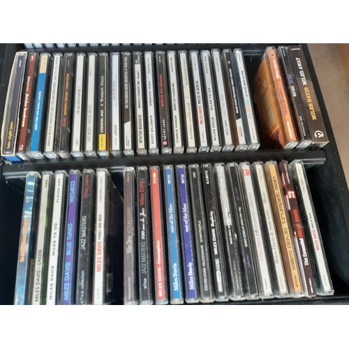 1136 - Four CD racks containing a collection of CDs to include Miles Davis, Dizzy Gillespie, Charlie Parker... 