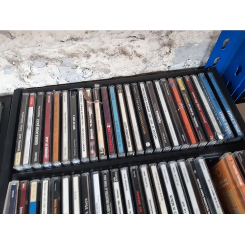 1136 - Four CD racks containing a collection of CDs to include Miles Davis, Dizzy Gillespie, Charlie Parker... 