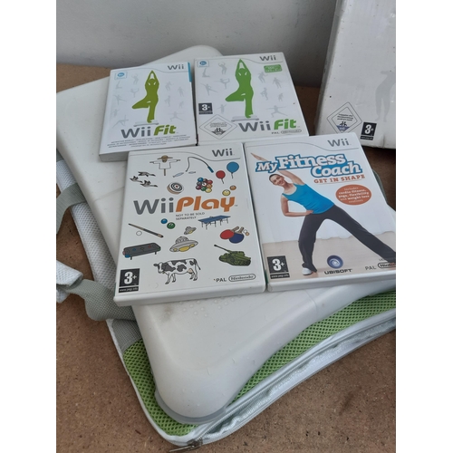 1143 - Three Nintendo Wii Balance Boards, one boxed white, one boxed black Plus and one cased with three ga... 