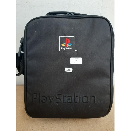 1145 - A cased Sony PlayStation SCPH-7502 with controller, power cable, RFU adaptor and seven games to incl... 