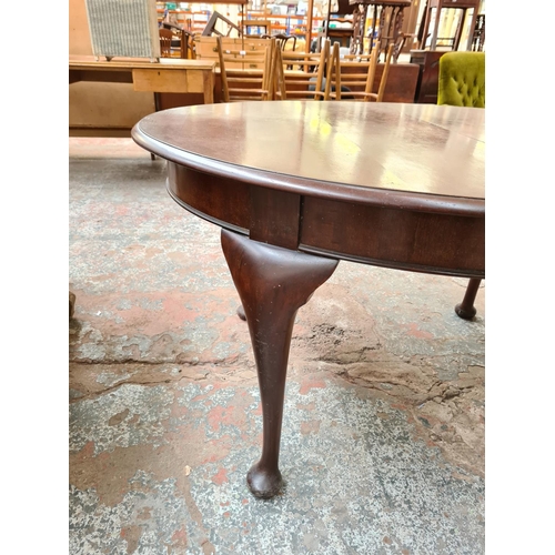 1026 - A mahogany oval wind out dining table on cabriole supports - approx. 73cm high x 135cm wide x 135cm ... 