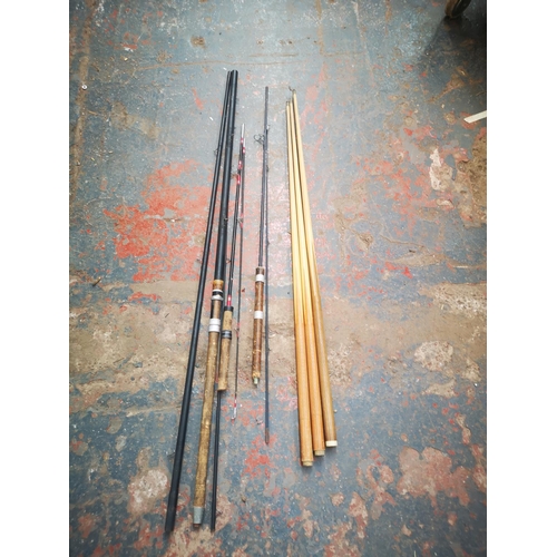 1391 - A vintage three piece fishing rod and three wooden pool cues