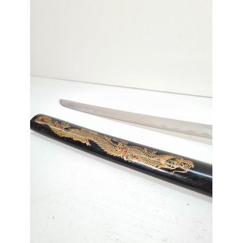 332 - A mid 20th century ornamental Japanese Samurai sword with black lacquered scabbard and dragon design