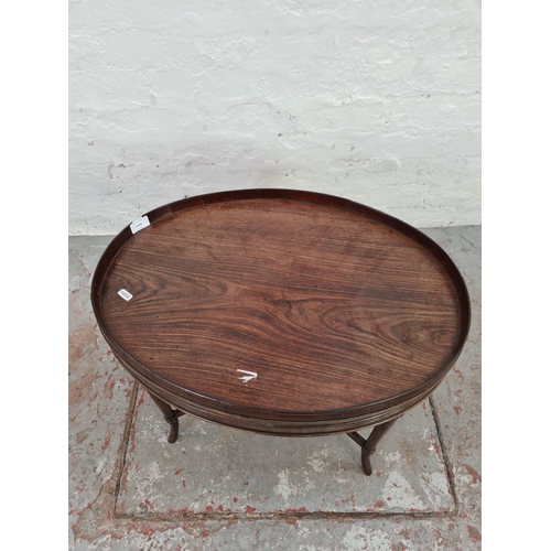 1008 - An Edwardian mahogany oval side table - approx. 48cm high x 45cm wide x 61cm long