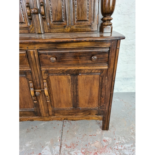 1010 - An Ercol Old Colonial dark elm court cupboard - approx. 124cm high x 123cm wide x 47cm deep