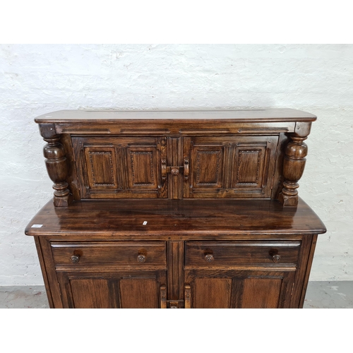 1010 - An Ercol Old Colonial dark elm court cupboard - approx. 124cm high x 123cm wide x 47cm deep