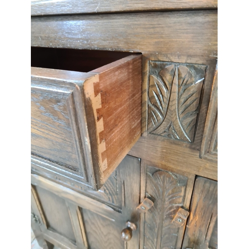 1015 - A Bevan Funnell Ltd. Reprodux oak dresser with carved floral decoration, two lower cupboard doors, t... 