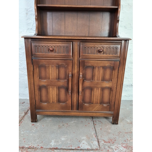 1016 - A Priory style oak dresser with two lower cupboard doors, two drawers and upper plate rack - approx.... 