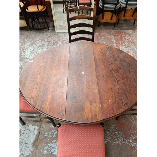 1027 - An early 20th century oak drop leaf gate leg dining table on barley twist supports with four later o... 