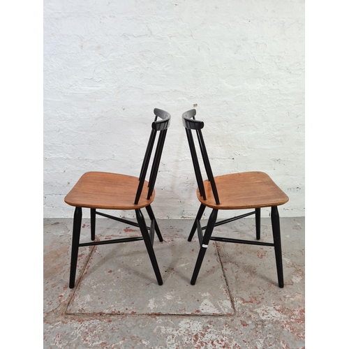 1042 - A pair of mid 20th century black painted elm spindle back dining chairs