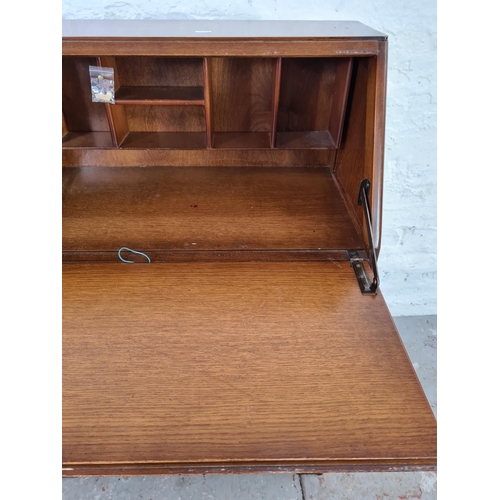 1047 - A Jentique oak bureau with two lower cupboard doors and fall front - approx. 107cm high x cm 76cm wi... 