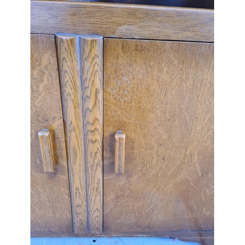 1047 - A Jentique oak bureau with two lower cupboard doors and fall front - approx. 107cm high x cm 76cm wi... 