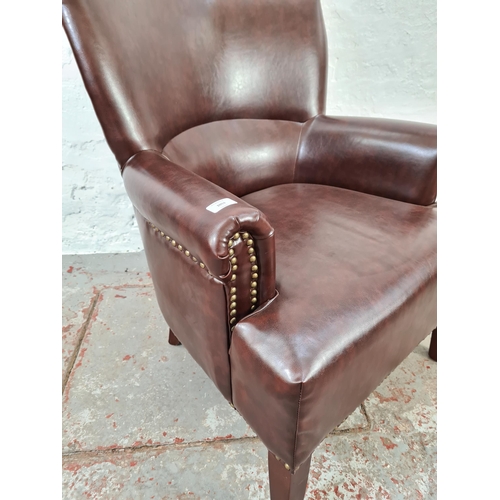 1053 - A Victorian style brown leather brass studded armchair - approx. 92cm high x 68cm wide x 70cm deep