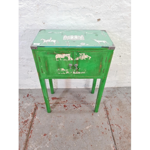 1055 - A vintage green painted two door cabinet with country scene printed top - approx. 74cm high x 51cm w... 