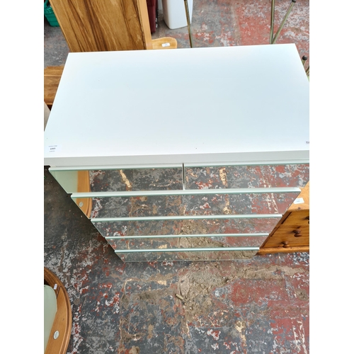 1065 - A modern white and mirrored glass chest of two short over four long drawers - approx. 104.5cm high x... 