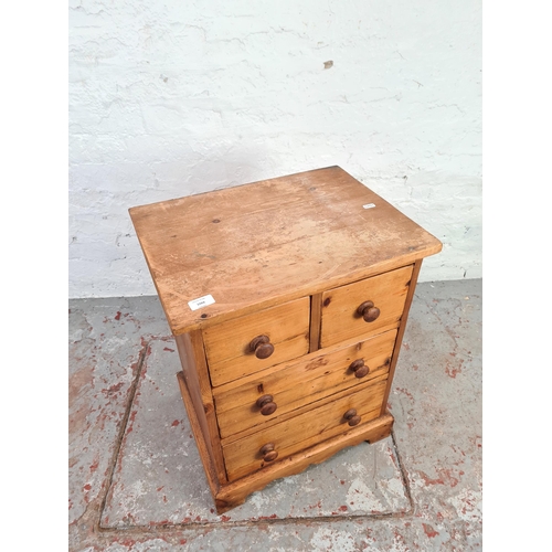 1066 - A modern solid pine miniature chest of two short over two long drawers - approx. 63cm high x 50cm wi... 