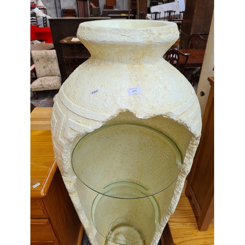 1072 - A contemporary fibreglass Ancient Greek style vase illuminating display cabinet with two internal gl... 