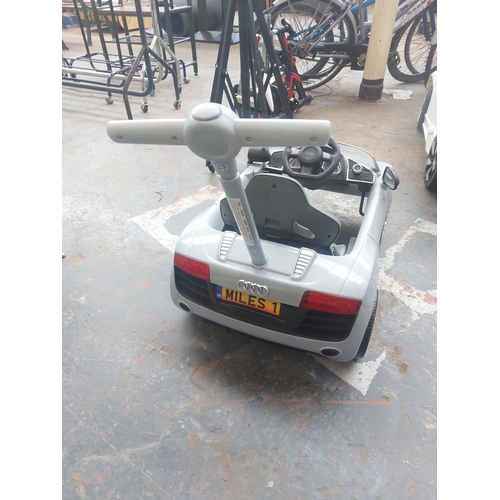 1220 - A grey Audi R8 Spyder child's ride on electric car with rear safety handle