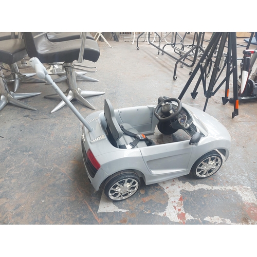 1220 - A grey Audi R8 Spyder child's ride on electric car with rear safety handle