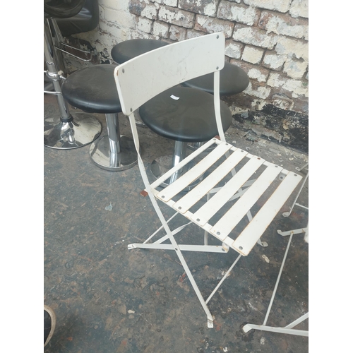 1232 - A five piece white painted metal folding patio set comprising table with square top and four matchin... 